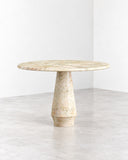 ETAMORPH Stilo Ceppo Sicilia Dining Table features a round stone tabletop with a richly textured, speckled surface and a tapered sculptural pedestal. Its natural patterning and restrained silhouette create a distinctive focal point for contemporary dining interiors.
