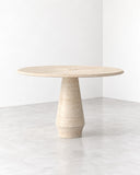 ETAMORPH Stilo Classic Travertine Dining Table features a round tabletop and tapered central pedestal in warm beige travertine. Its softly textured stone surface and minimalist proportions bring timeless natural elegance to contemporary dining spaces.