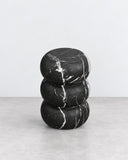 ETAMORPH Tubby Side Table features three rounded, stacked forms in black marble with bold white veining. Its compact sculptural silhouette and contrasting stone pattern create a distinctive accent for modern living spaces.