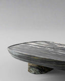 Marble-patterned round object on a light gray background