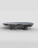 Marble-patterned stone pedestal on a light gray background