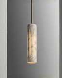 Cylindrical pendant light with marble-like texture on a gray background. AURA Pendant | Modern Designer Lighting