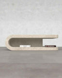 Modern concrete shelf against a gray wall with 'ALWEN' branding. FOLD | Marble Travertine Coffee Table | Limited Edition