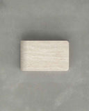 Rectangular beige stone block on a gray background. FOLD | Marble Travertine Coffee Table | Limited Edition