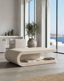 Modern living room with a stone coffee table and large windows overlooking a scenic view. FOLD | Marble Travertine Coffee Table | Limited Edition