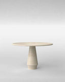 Round stone table with a textured base on a light gray background. STILO Classic Travertine | Designer Dining Table