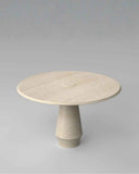 Round stone table with a textured surface on a gray background