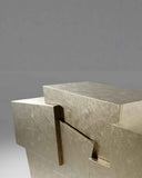 Sculptural cabinet crafted from natural stone and metal detailing. A designer storage piece inspired by monolithic architectural forms.