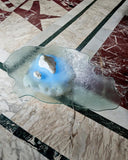 Luxury sculptural coffee table crafted from glass. Designed to bring depth and movement to interiors.