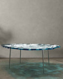 Sculptural glass dining table with an organic surface pattern. Inspired by natural ice formations and contemporary design.
