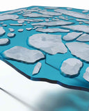 Designer glass table featuring layered sculptural detailing. A statement piece for luxury interiors.