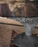 Contemporary statement table with sculptural stone-inspired detailing. Crafted to create visual impact in modern spaces.