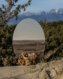 Luxury sculptural mirror featuring an expressive organic base. Designed for contemporary living environments.