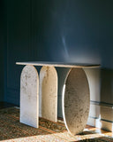 Designer travertine console table with handcrafted stone detailing. Crafted for sophisticated residential interiors.