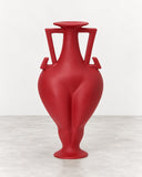 IAMMI Bfora Size M is a sculptural red vase featuring a rounded body, elongated neck, and distinctive angular handles. Its bold colour and expressive silhouette make it a striking decorative object for contemporary interiors.