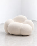 IAMMI Cloud Lounge Chair featuring a soft, cloud-inspired silhouette formed by generously upholstered rounded sections in a warm ivory tone. Its enveloping sculptural shape and plush appearance bring a relaxed, contemporary character to luxury living spaces.