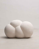 Contemporary pouf with rounded sculptural proportions and refined craftsmanship. Designed to complement sophisticated living spaces.