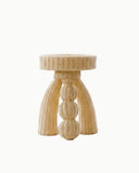 Sculptural side table handcrafted from woven natural fibre with a rounded organic silhouette. A designer side table for contemporary luxury interiors.