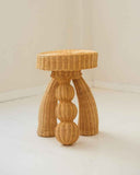 Contemporary side table featuring artisanal woven fibre and sculptural craftsmanship. Designed as a statement accent table for modern living spaces.