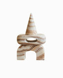 Sculptural marble object crafted from pink marble with a refined contemporary silhouette. A designer accent object created for luxury modern interiors.