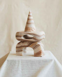 Contemporary pink marble object featuring sculptural geometry and natural stone veining. Designed as a statement furniture piece for sophisticated living spaces.