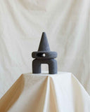 Designer accent table made from natural volcanic rock with a sculptural contemporary silhouette. Crafted for sophisticated residential interiors.