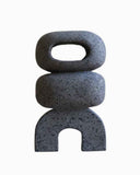 Sculptural object handcrafted from natural volcanic rock with a minimalist contemporary profile. A designer stone object for luxury interiors.