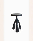 TSculptural side table handcrafted from solid timber with an architectural contemporary profile. A designer wooden side table for luxury interiors.