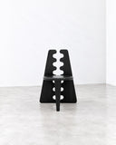 METAMO Venus Dining Chair featuring a black geometric frame with a rounded seat and distinctive sculptural cutouts along its central supports. Its bold, architectural construction gives this contemporary dining chair a distinctive artistic presence.