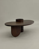 Luxury timber dining table featuring a sculptural pedestal base. Designed as a statement piece for modern spaces.