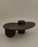 Contemporary sculptural table crafted from solid timber. A statement furniture piece for luxury interiors.
