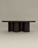 Sculptural solid wood coffee table with a monolithic profile. A designer centre table inspired by architectural forms.