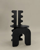 Luxury timber chair with a handcrafted geometric silhouette. Designed as a statement seating piece for contemporary interiors.