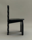 Contemporary wooden chair showcasing sculptural craftsmanship. Crafted to combine comfort and collectible design.