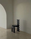 Sculptural chair with distinctive carved detailing and organic forms. Designed for modern residential interiors.