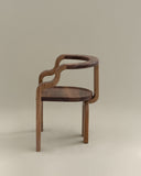 Contemporary wooden chair showcasing sculptural craftsmanship. Crafted to balance comfort and artistic design.
