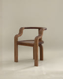 Designer chair with a solid wood frame and organic silhouette. A statement seating piece for modern interiors.