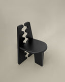 Luxury timber chair with a bold architectural silhouette. Designed as a statement seating piece for modern interiors.