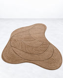 Noemi Saga Nouveau Art Rug featuring an irregular organic outline in warm brown, decorated with fine flowing contour lines. Its layered linear pattern and earthy palette create a subtle, sculptural accent for contemporary interiors.