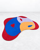 Noemi Saga Nouveau Guto Lacaz Edition Art Rug featuring an abstract, asymmetrical composition of vivid red, cobalt blue, white, and yellow shapes. Its playful colour blocking and fluid outline bring an expressive artistic statement to contemporary interiors.
