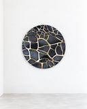Onno Adriaanse ClayDisc SII Gold wall sculpture featuring an irregular gold crackle pattern across a dark circular surface. Its contrasting metallic lines and organic geometry create a distinctive contemporary decorative wall accent.