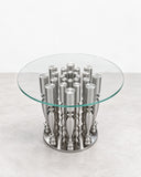 Paolo Giordano Popclassic Coffee Table featuring a circular transparent glass top above a cluster of polished metal cylindrical supports. Its reflective sculptural base and clean glass surface create a distinctive contemporary centrepiece.