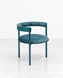 RIES Aro Chair Verdeingles featuring a slim teal frame, rounded upholstered seat, and curved wraparound backrest. Its clean lines and compact sculptural silhouette bring a fresh contemporary accent to dining spaces.