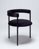 Contemporary upholstered chair in black with a sculptural silhouette and refined detailing. Designed as a statement seating piece for modern interiors.