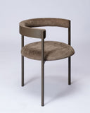 Designer chair upholstered in chinchilla fabric with organic curves and premium craftsmanship. Crafted to combine comfort with contemporary design.