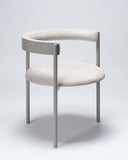 Sculptural lounge chair upholstered in Mika fabric with soft organic contours. Designed as a collectible seating piece for contemporary interiors.