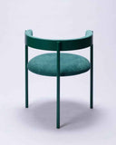 Sculptural upholstered chair featuring elegant curves and a Verde Ingles fabric finish. A designer seating piece for luxury modern interiors.