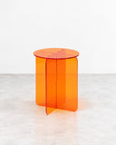 RIES Roma Round Side Table Naranja featuring a transparent orange circular top and intersecting translucent panel supports. Its bright colour and crisp geometric construction create a playful contemporary accent table.