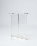 Round acrylic side table featuring a minimalist contemporary silhouette and polished finish. A sculptural accent table for refined residential spaces.