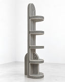 Richard Yasmine AlterAgo Bookcase featuring a tall, sculptural vertical frame with curved, ribbed shelves arranged at varying heights. Its distinctive linear detailing and architectural silhouette make it a striking contemporary storage piece.